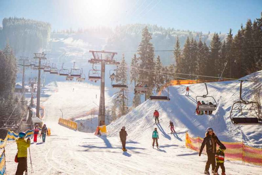 Image skiers ski lift riding up ski resort